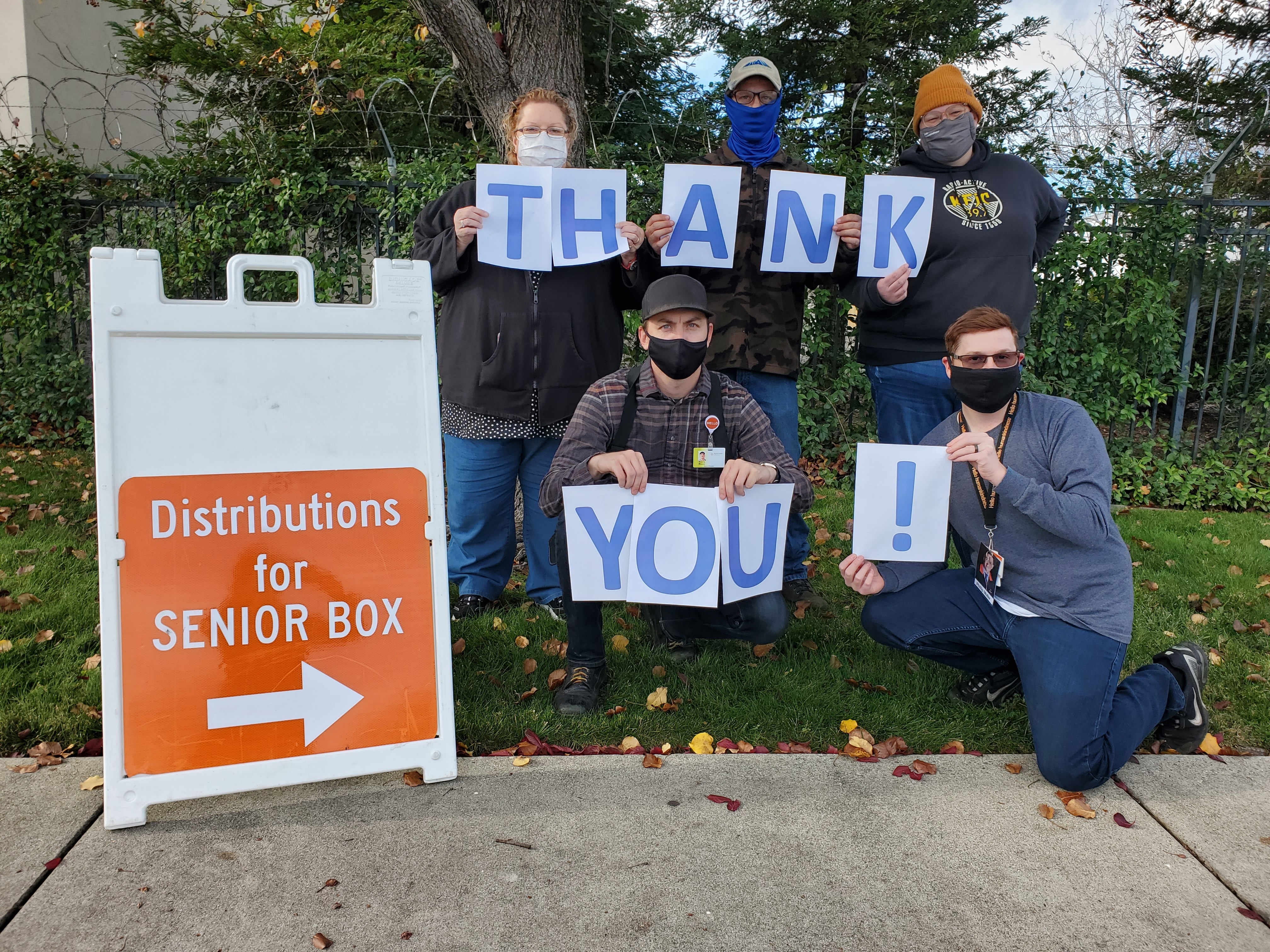 Employees holding up Thank You signs