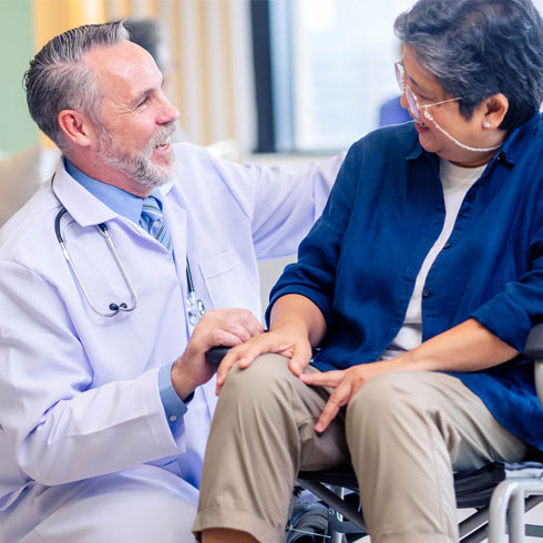 Woman in wheelchair next to male medical provider