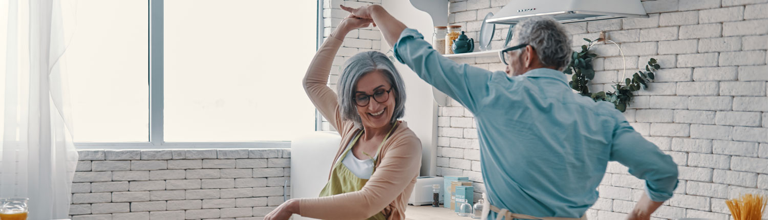 Senior couple dancing in the kitchen