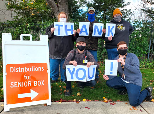 Employees holding up thank you signs